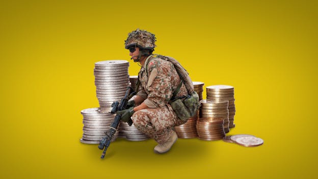 A soldier kneeling next to stacks of coins Description automatically generated